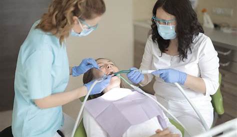 A Dentist Working On Her Patient's Teeth · Free Stock Photo