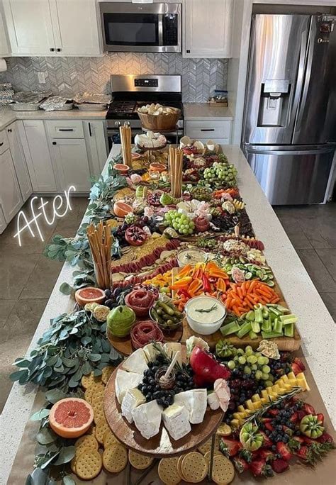 A Long Table Filled With Lots Of Food On Top Of A Kitchen Counter Next