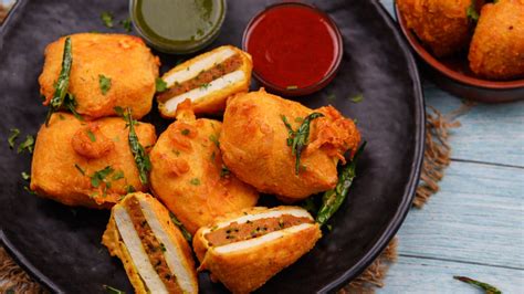 Making golden fried paneer pakoda sandwiches