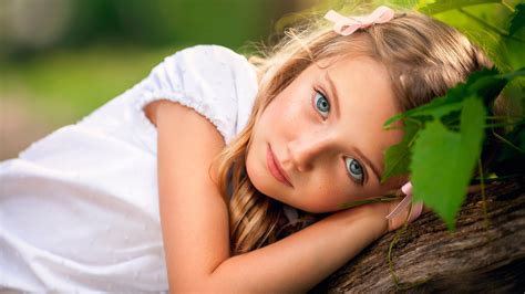Ash Eyes Cute Little Girl Is Lying On Tree Trunk Wearing White Dress In