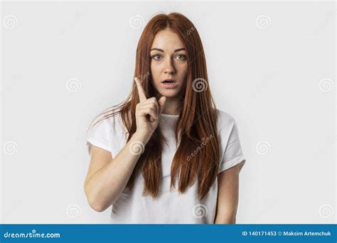 Beautiful Redhead Woman Keeping Finger Pointed Upwards Showing