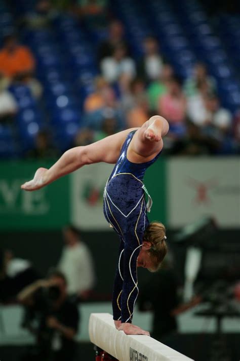 artistic female gymnast julie martinez fra performing her routine on the balance beam