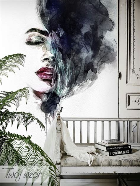 A Painting Of A Womans Face On The Wall Next To A Bed With A Plant