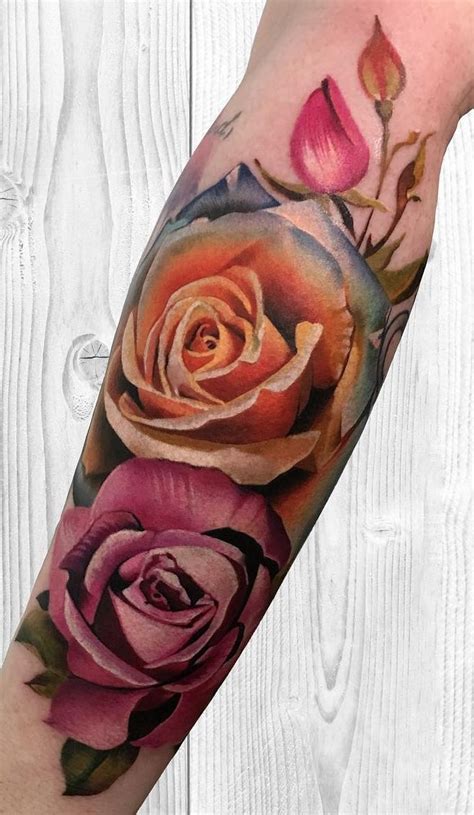 A Rose Tattoo On The Arm With Pink And Red Roses In Its Center