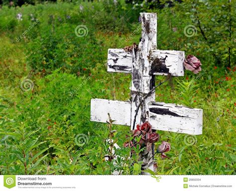 This is usually accomplished by excavating a pit or trench, placing the deceased and objects in it, and covering it over. Old Wooden Cross At A Russian Cemetery Stock Photo - Image of roses, life: 20650334