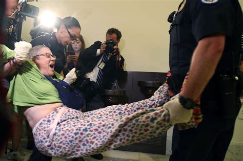 “no cuts to medicaid ” protesters in wheelchairs arrested after