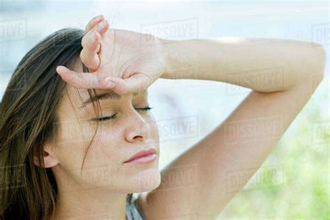 Woman With Hand On Forehead Stock Photo Dissolve