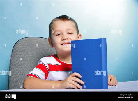Child Boy Kid Reading A Book On Blue Stock Photo Alamy