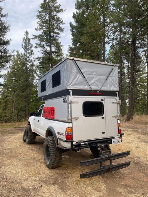 A Truck With A Camper Attached To The Back