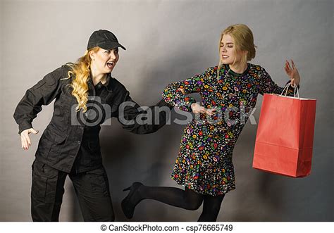 Security Guard And Shoplifter Shoplifting Is A Crime Young Fashionable Woman Being Caught On