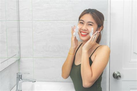 Beautiful Young Woman Washing Her Face Foam In A Bathroom Stock Image