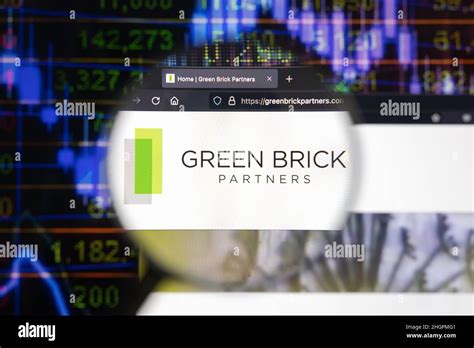 Green Brick Partners Company Logo On A Website With Blurry Stock Market