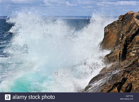 Waves Crashing Into Rocks Of Cliff Along The Brittany Coast France