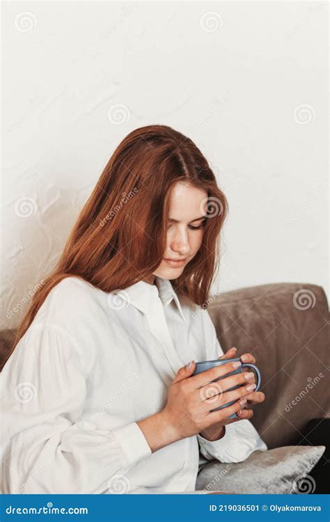 Portrait Of A Brooding Teenage Girl Sitting On A Chair Stock Image