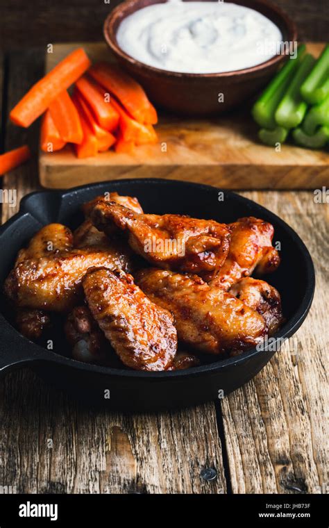 Roasted Chicken Wings With Carrots Celery And Dipping Sauce On Rustic