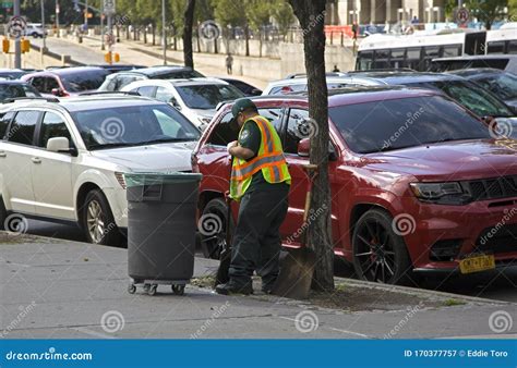 Nyc Department Of Sanitation Worker Cleaning Sidewalk Of Debris On
