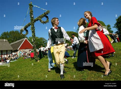 Sweden Midsummer Happy People Dance Around The Green Maypole