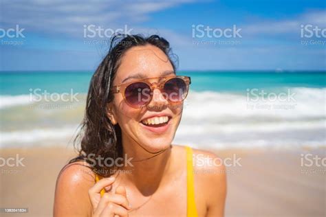 Portrait Of Young Woman Relaxing On Tropical Beach Stock Photo