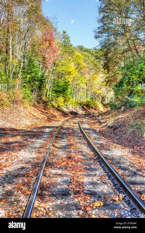 Railroad Tracks In Autumn Fall In West Virginia With Golden Foliage