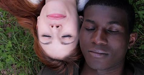 Mixed Love Conceptinterracial Young Couple Lying On Lawn Opening Eyes