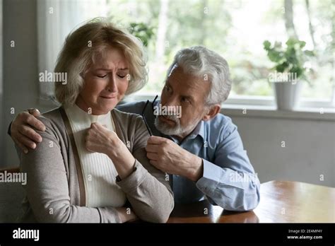 Close Up Mature Man Comforting Frustrated Crying Wife Hugging Stock