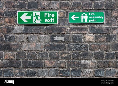 Fire Exit Signs On Old Brick Wall At Middleport Pottery Stoke On Trent