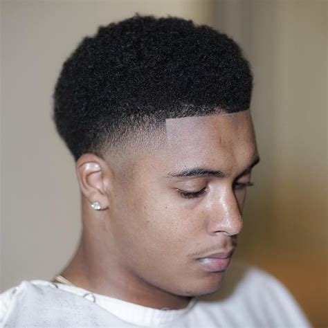 This is a neat hairstyle featuring very short hair with light faded curls at the top. Pin on Fade Haircuts For Black Men
