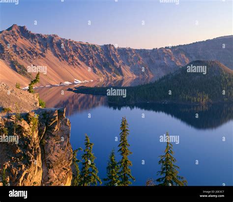 Usa Oregon Crater Lake National Park Sunrise Glow On West Rim Of