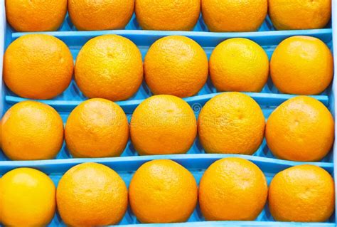 Fresh Bright Oranges Neatly In A Row Laid Out In A Box On The Market In