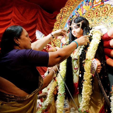 An Indian Sex Worker Garlands An Idol Of Hindu Goddess Durga At A Worship Place Set Up By Sex