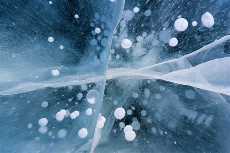 Beautiful Ice Of Lake Baikal With Abstract Cracks And Frozen Air