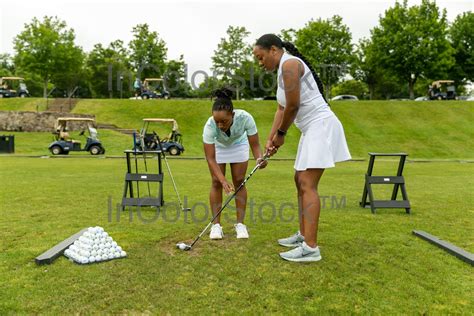 8 Black Female Golfer Helping Other Black Female Golfer Commercial — Incolorstock