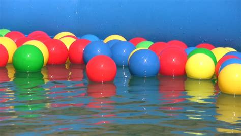 Multicolored Balls Floating In Inflatable Water Pool Stock Footage