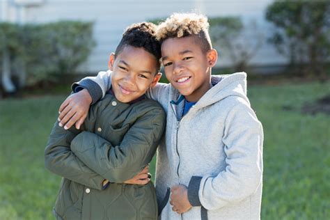 Confident Mixed Race Boys Brothers Standing Together Stock Photo