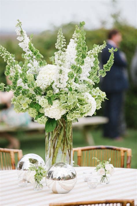 Such as in our collection of pictures of beautiful bouquets! Green and White Tall Floral Centerpiece | Photo: Willett ...