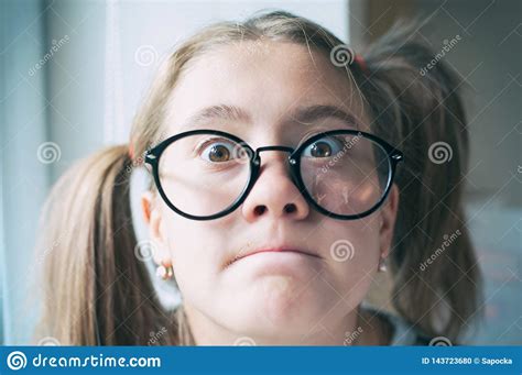 Portrait Of Glad Funny Surprised Girl With Ponytails In Glasses Stock
