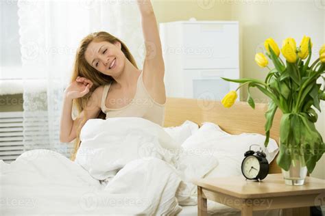 Woman Waking Up In The Bed 1179358 Stock Photo At Vecteezy