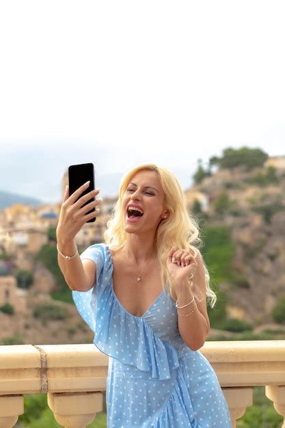 Premium Photo Graceful Blonde Woman In Her 40s Taking Selfies