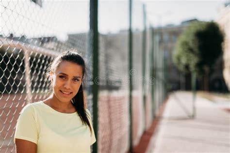 Portrait Of Attractive Lady Posing Near Chain Fence Outdoors Stock