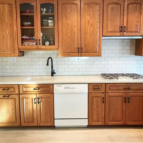 An elegant cabinet design job will entail a lot of attention to detail, design imagination in combining functionality with beauty and. Oak cabinets with cream subway tiles & dark grout # ...