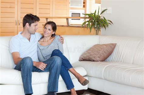 Smiling Couple Sitting On A Couch Stock Images Image 22660754