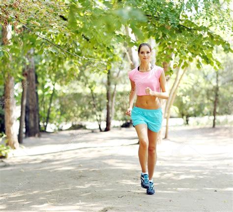 Woman Jogging At Park Stock Photo By ©belchonock 52340035