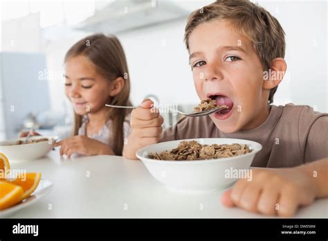 Boy Eating Cereal While Having Breakfast Stock Photo Alamy