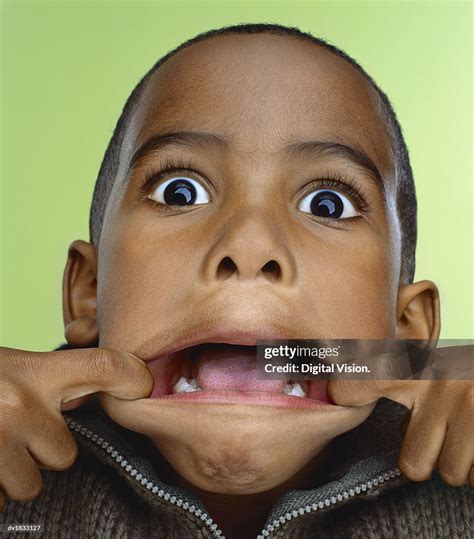 Portrait Of A Young Boy Pulling A Silly Face High Res Stock Photo
