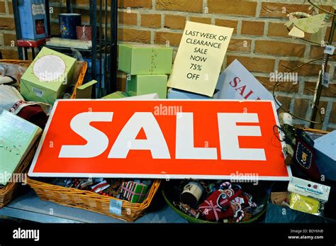Sale Sign In Red And White On Stall With Goods Behind Stock Photo Alamy