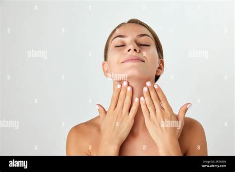 Beautiful Young Woman Taking Care After Skin Doing Face Massage With Hands Isolated On White