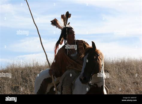 A Native American Indian Man Siting Bareback On A Horse Riding The