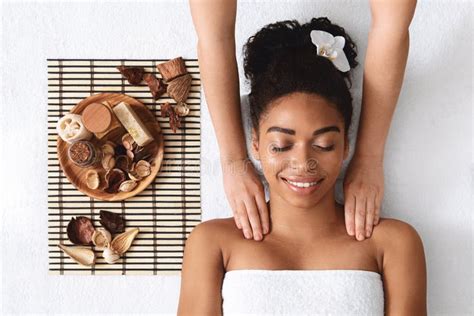 Slim Black Woman Receiving Full Body Massage At Modern Spa Stock Image