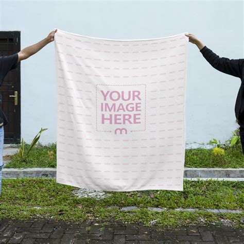 Mockup Of Two People Holding The Top Of A Blanket Mediamodifier