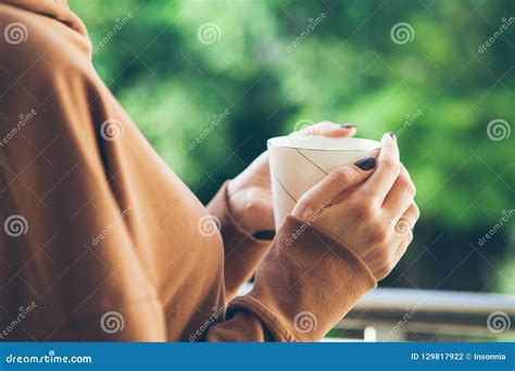 Caucasian Woman Enjoys Spare Time And Drinks Cup Of Tea Stock Photo